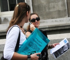 Girl makes a phone call trying to find an answer on the Chelsea Treasure Hunt.