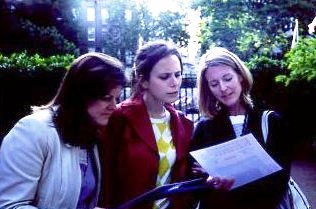 Three girls reading a treasure hunt clue.