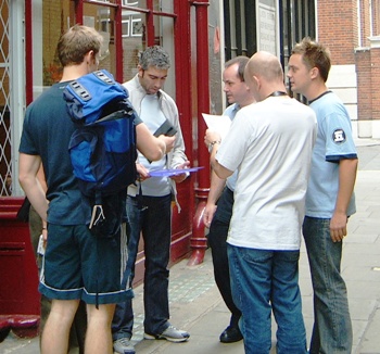A treasure hunt team outside a London shop.