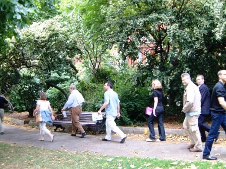 Group of people walking through street on a treasure hunt.