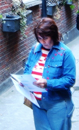 Woman reads a treasure hunt clue in Westminster.