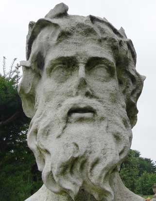 A carved stone face in the grounds of Chiswick House .