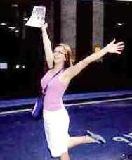 A girl holds her arms in the air.