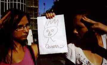 Woman holding up a picture she has drawn of the Queen as part of a docklands treasure hunt.