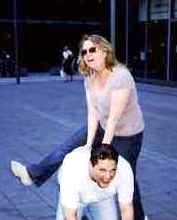 Woman leap frogging over a man.