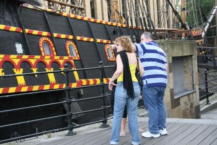 Couple by a ship on the docklands treasure hunt.