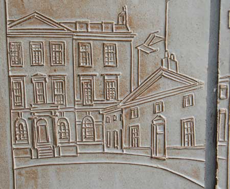 A carving of a street scene in Mayfair.