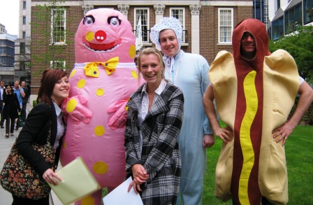 Two team members posing with Mr Blobby.