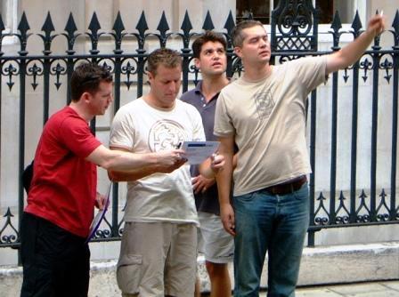Men pointing up at a clue.