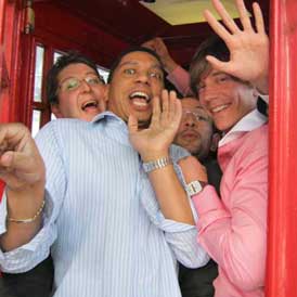 A trreasure hunt team inside a phone box as one of their challenges.