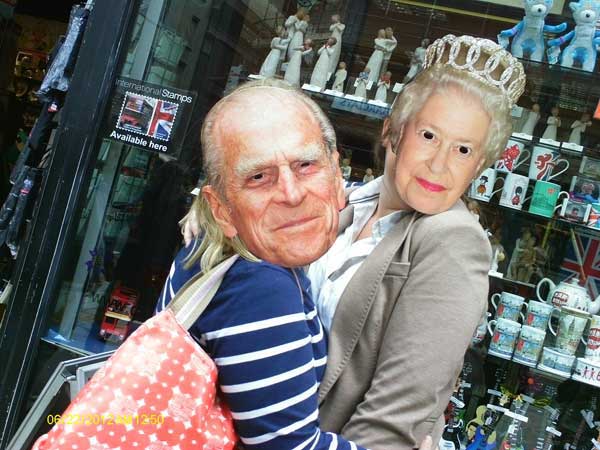 Two treasure hunt participants wearing masks of the Queen and Prince Phillip.