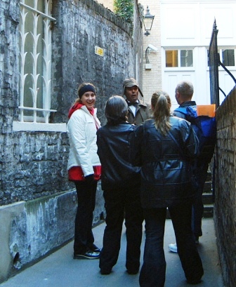 Group discussing a treasure hunt clue with Sherlock Holmes.
