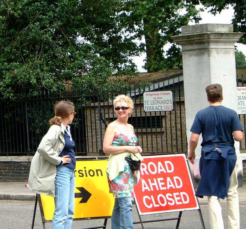 People stopping by a Road Closed sign on the Chelsea Treasure Hunt.