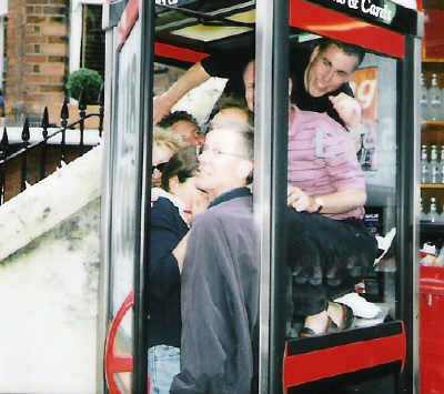 A team in a phone box on the treasure hunt.