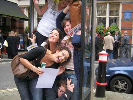A team crowd into a London phone box.
