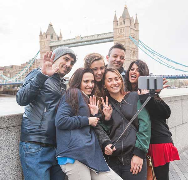 A team by Tower Bridge posing for a challenge on the Riverside Treasure Hunt.