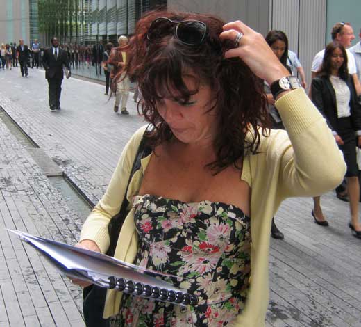 A woman reads a treasure hunt clue and scratches her head.