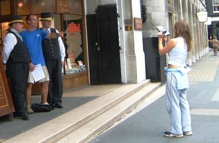 Woman photographing a man as a treasure hunt task.