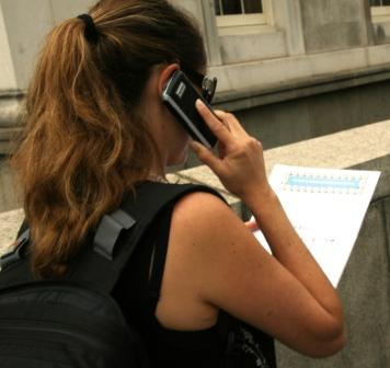 Woman on phone seeking answer to question on the St James Treasure Hunt.