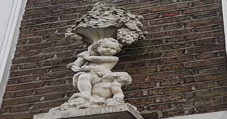A carving of a cherub on a Bloomsbury wall.