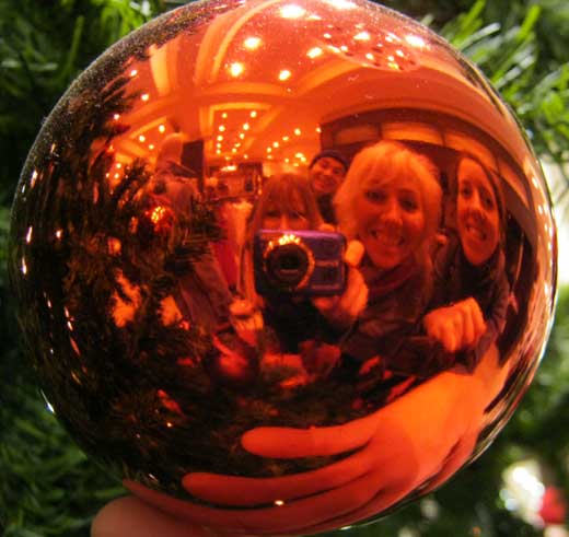 A photograph of a team reflected in a baubel..