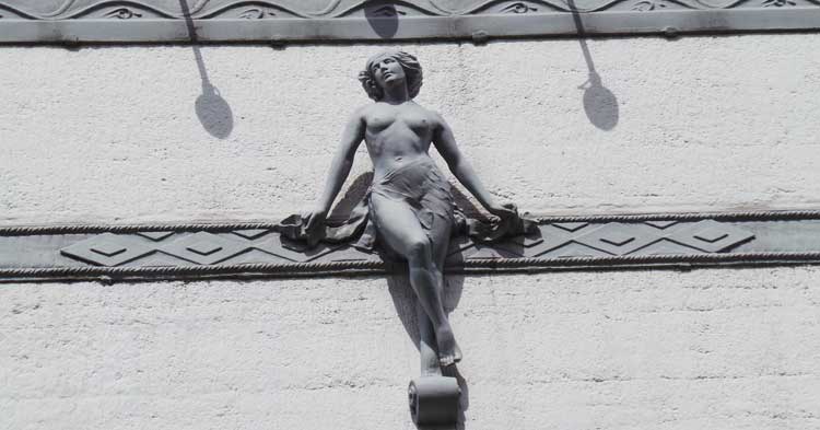 The statue of a lady over the Fortune Theatre.