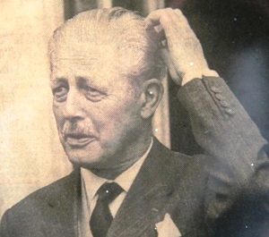 Harold Macmillan scratching his head.