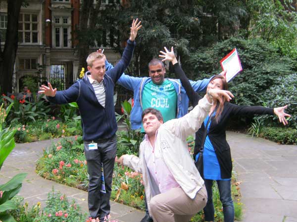 A team imitate the spreading brranches of a tree as one of their challenges.