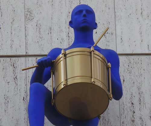 The blue figure playing a drum that appears at some point on the treasure hunt.