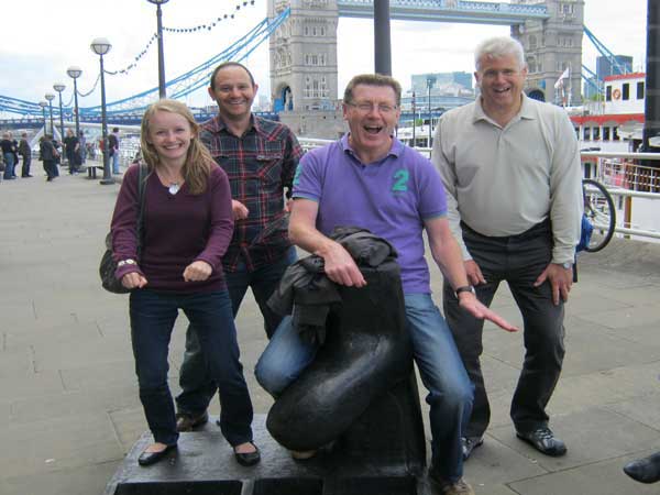 Three people posing for a challenge with Tower Bridge in the background.