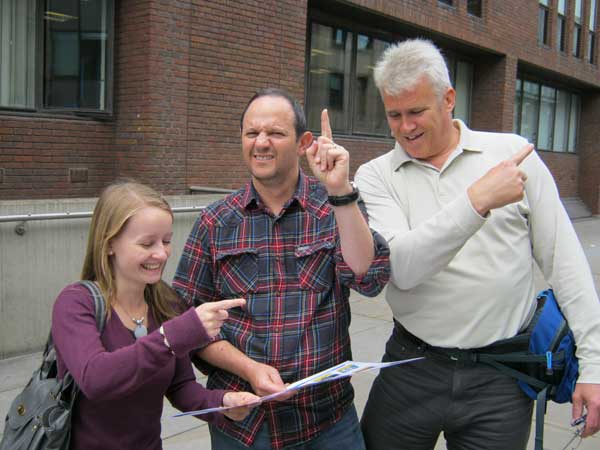 Three people deciding which way to go on a self-managed treasure hunt.